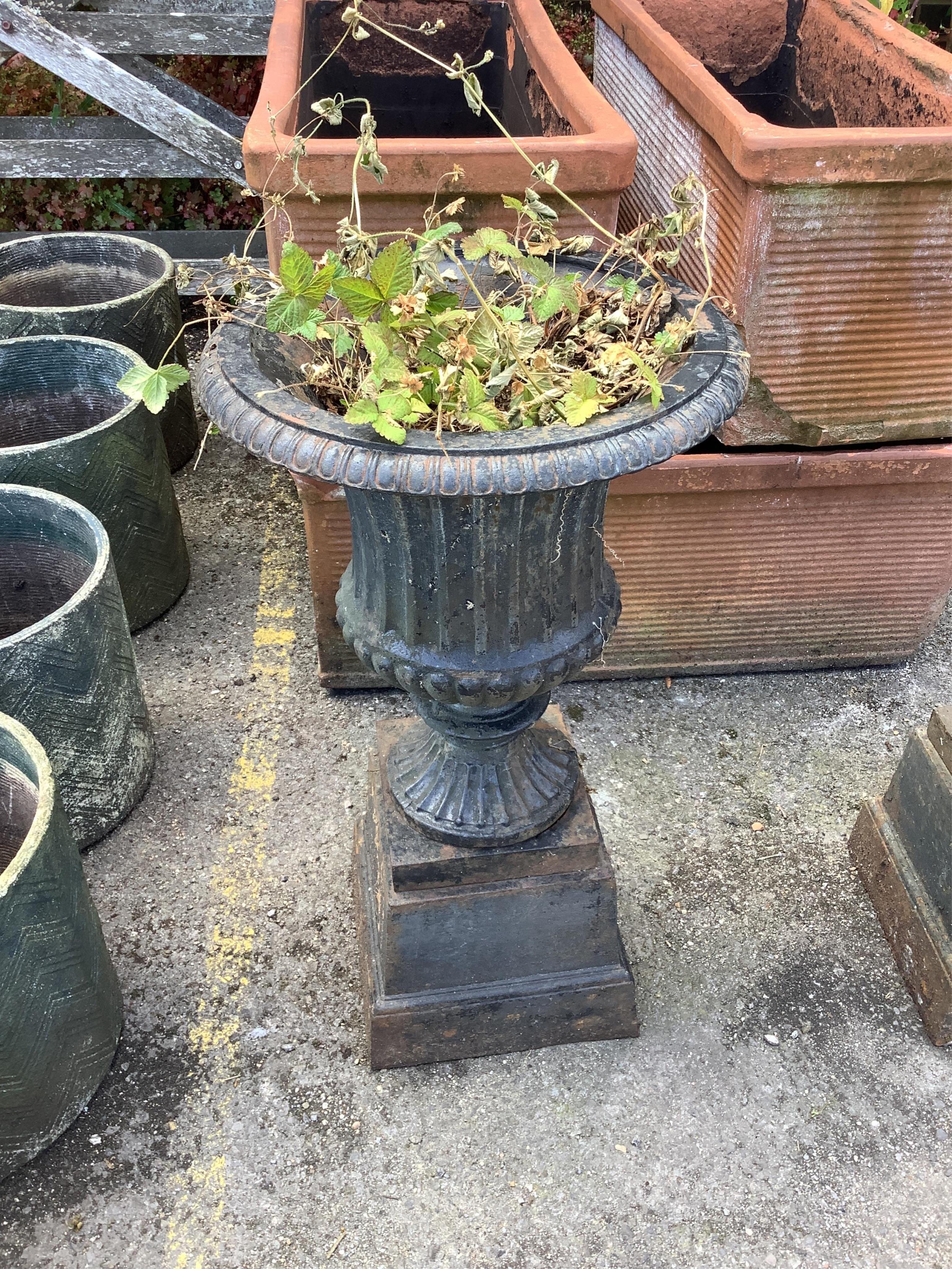 A pair of Victorian style circular black painted cast iron campana urns on stands, diameter 38cm, height 67cm. Condition - fair